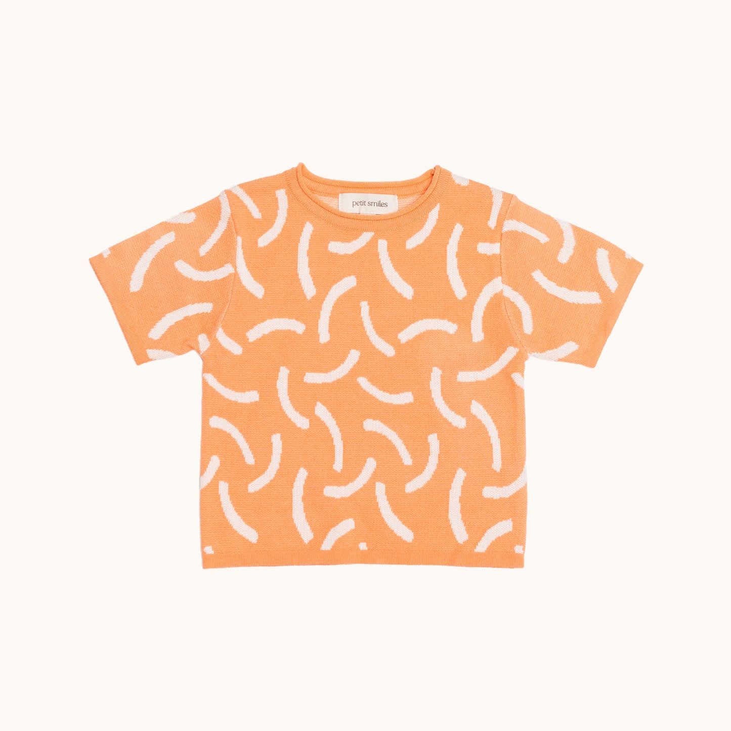 KNITTED BRUSH ORGANIC TEE – CORAL/CREAM; 100% Organic Cotton; Made from GOTS-certified organic cotton; 'BRUSH' Jacquard pattern; Rolled edge at the neckband; Rib finish at hem and cuffs; Dropped shoulder; Relaxed fit