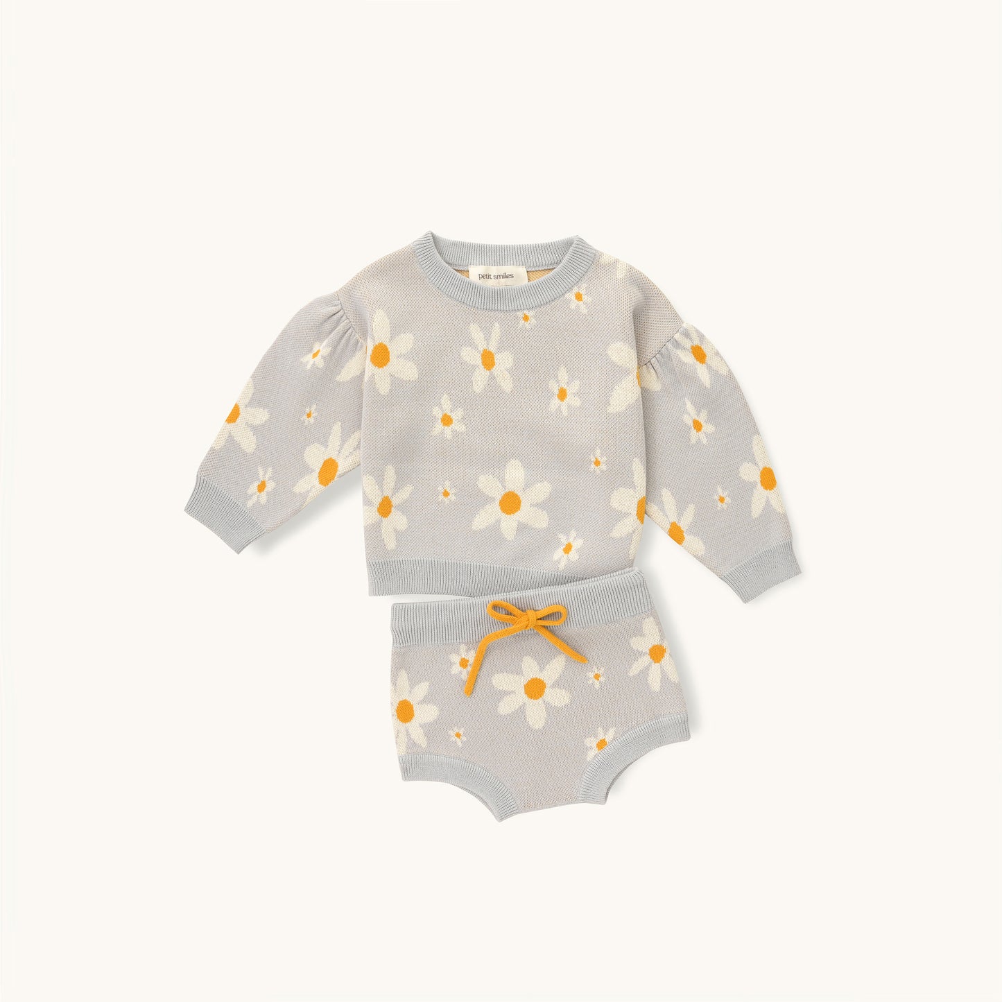 KNITTED PULL OVER - FLORAL; 100% Organic Cotton; Jacquard Pull Over made from GOTS-certified organic cotton; 'Floral' Jacquard pattern; Dropped shoulder, with gathered sleeves; Rib finish and neck, hem and cuff; Model wears size 3.